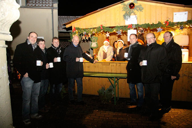 Kürnacher Weihnachtsmarkt  Einstimmung in den Advent Kürnach   Kalt war es am Platz hinter dem Haus der Vereine und neben der Kirche. Dies tat der Stimmung aber keinen Abbruch. Der Kirchberg verwandelte sich beim Kürnacher Weihnachtsmarkt in ein Lichtermeer weihnachtlicher Stimmung. In festlich geschmückten Hütten wurde verschiedenes Kunsthandwerk, historische Körnier Rezepte und weihnachtliches Gebäck angeboten. Unzählige Besucher erlebten einen stimmungsvollen Weihnachtsmarkt und ließen sich von dem tollen Programm der Kürnacher Vereine verzaubern. Adventlicher Gesang des Kinder- und Jugendchores und des Gesangvereins, Blasmusik, Kinderkarussell, duftender Glühwein, frische Feuerzangenbowle, Körnier Mousdgöüger, Bratwürste, Schmalzbrot, weihnachtliche Leckereien und das Aroma frisch gebrannter Mandeln hatte eine Vielzahl an Gästen auf den Advent eingestimmt. Bürgermeister Thomas Eberth freute sich über den Zuspruch weit über den Erwartungen und lobte die ehrenamtlichen Helferinnen und Helfer: „Wieder grandios, was die Kürnacher Vereine hier gezaubert haben. Eine schöne und friedliche Attraktion im Kürnacher Jahreskreis“. Sowohl die Kinder als auch die Erwachsenen zeigten sich begeistert von ihrem Weihnachtsmarkt. Insofern wunderte es nicht, dass sehr viele über Stunden vergnüglich am Kirchberg verweilten, bis schließlich der Nachtwächter seinen Spruch hören ließ: „Hört, Ihr Leut’, und laßt euch sagen, unsere Glock’ hat zehn geschlagen! Dieser Weihnachtsmarkt ist aus, geht nun all’ geschwind nach Haus.“  Bildunterschrift Weihnachtsmarkt2: Stimmten sich bei einer Tasse „Körnier Mousdgöüger“, heißer Apfelmost mit Gewürzen auf die vorweihnachtliche Zeit ein. Von links: die Mitorganisatoren des Kürnacher Weihnachtsmarktes Stefan Scheller und Michael Fleischer, 1. Bürgermeister Thomas Eberth, Landrat Eberhard Nuss, Dominik Stiller von der Nahverkehr Würzburg-Mainfranken GmbH und Gemeinderat Dr. Alexander Schraml. In der Bildmitte Jutta Melzer und 2. Bürgermeisterin Sieglinde Bayerl, die den heißen „Mousd“ für den Arbeitskreis Geschichte verkauften.  